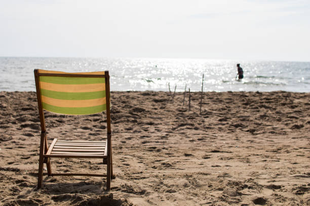 istock Small deck chair on the sand of a beach 836641312