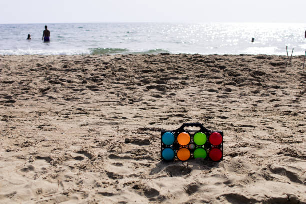 Set of colorful bowls for beach play with the sea in the background