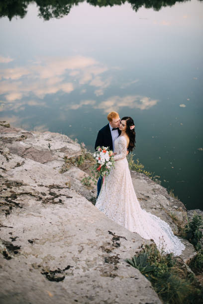 istock Happy newlyweds standing on the river bank 836641536