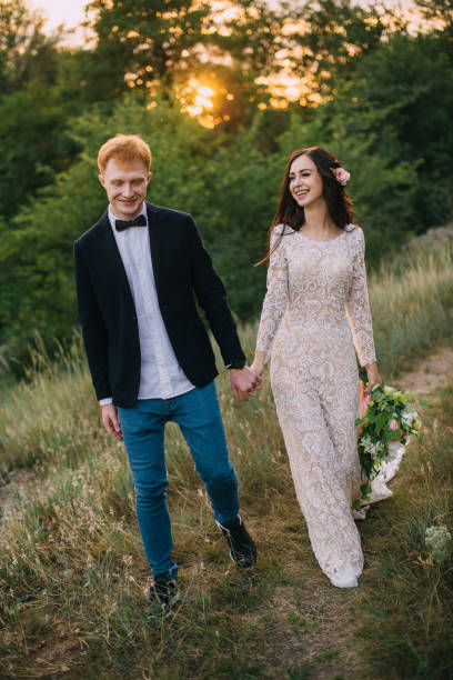 istock happy couple holding hands and walking 836642696