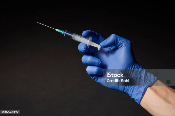Hand With Syringe Stock Photo - Download Image Now - Syringe, Hand, Black Background