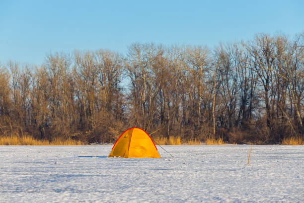 istock yellow touristic tent among a snowbound fields 836643732