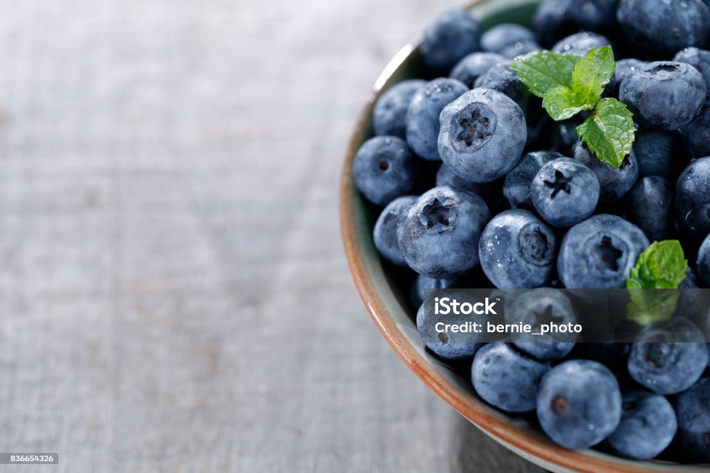 Blueberries on wooden table Full of blueberries close at the wooden table Blueberry Stock Photo