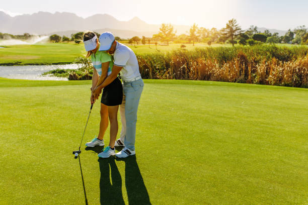 istock Male instructor showing woman to play golf 836656848