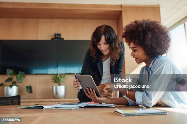 Professional Employees Discussing Project On Tablet Pc Stock Photo - Download Image Now