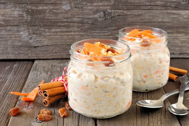 istock Carrot overnight oats with nuts and raisins in mason jars on rustic wood 836662456