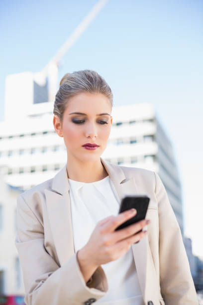 istock Serious attractive businesswoman sending a text message 836662736