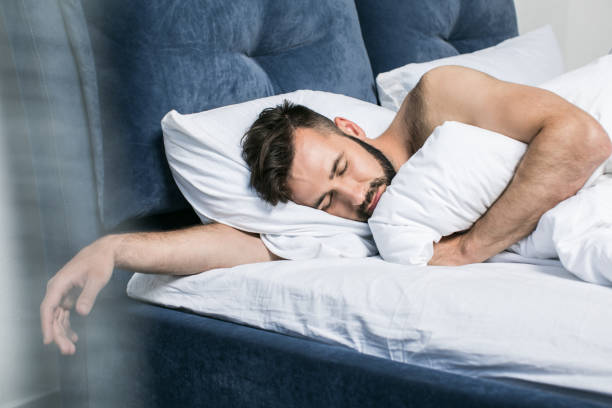 istock close-up view of handsome young bearded man sleeping in bed at home 836663194