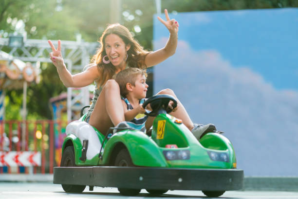 istock cheerful mom with little son in go cart 836665488