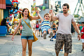 happy family enjoying summer day in amusement park