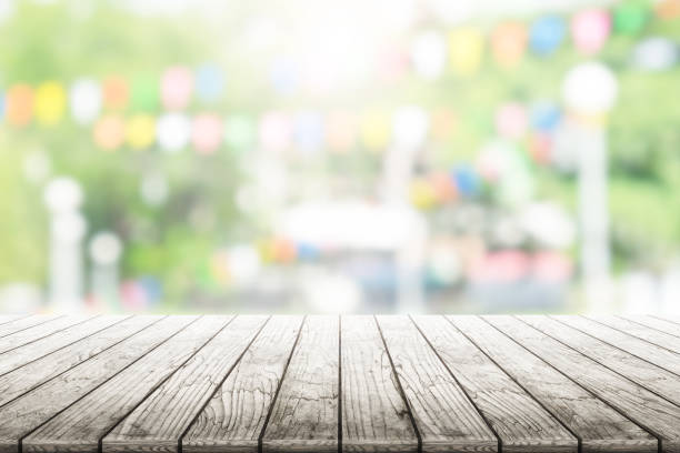 istock Empty wooden table with party in garden background blurred. 836665640