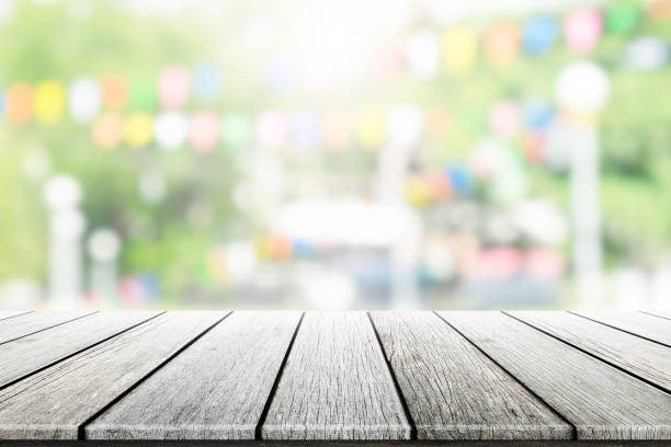 istock Empty wooden table with party in garden background blurred. 836665804