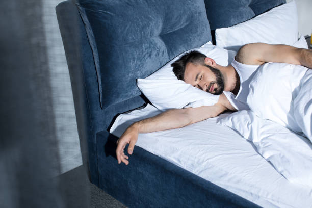 istock handsome young bearded man sleeping in bed at home 836665948