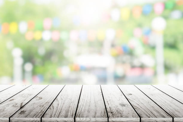 istock Empty wooden table with party in garden background blurred. 836666456