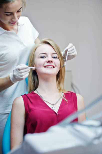 istock Gorgeous young female dentist checking her patient's teeth up in a specially-equipped cabinet. 836666532