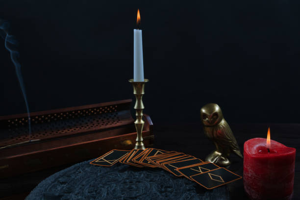 istock Magic ritual with runes cards and candles on black 836677084