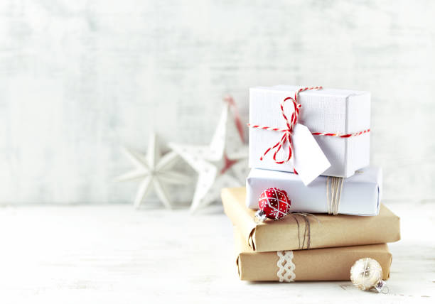 An Arrangement of Christmas Presents wrapped in gift paper in natural shades stock photo