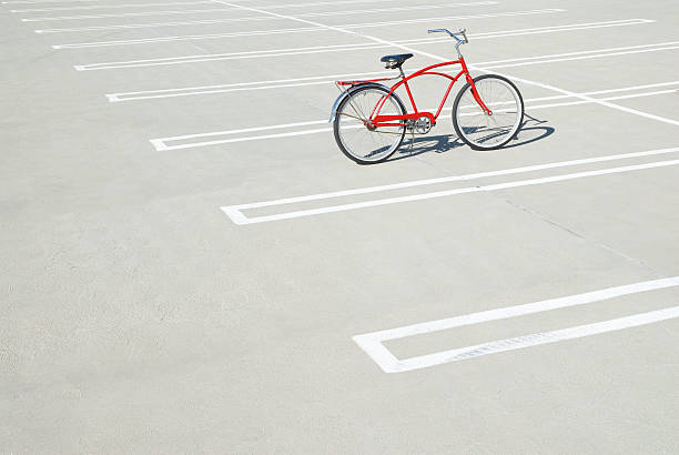 bike in empty parking lot. - bicycle parking 뉴스 사진 이미지