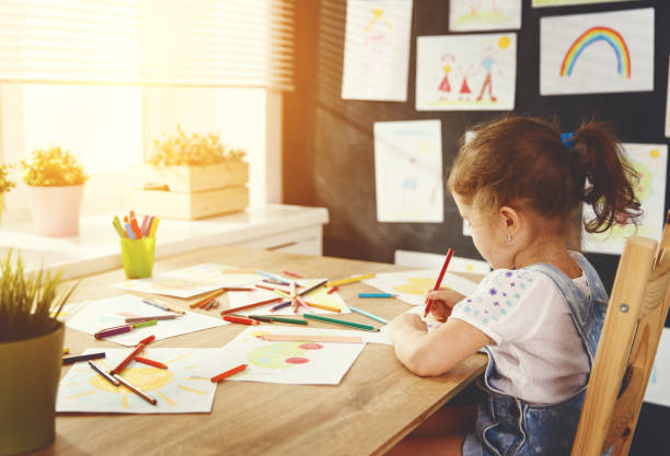 istock child  girl draws with colored pencils 836684546