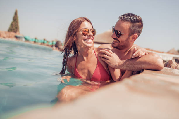 istock Couple having fun in swimming pool 836684882