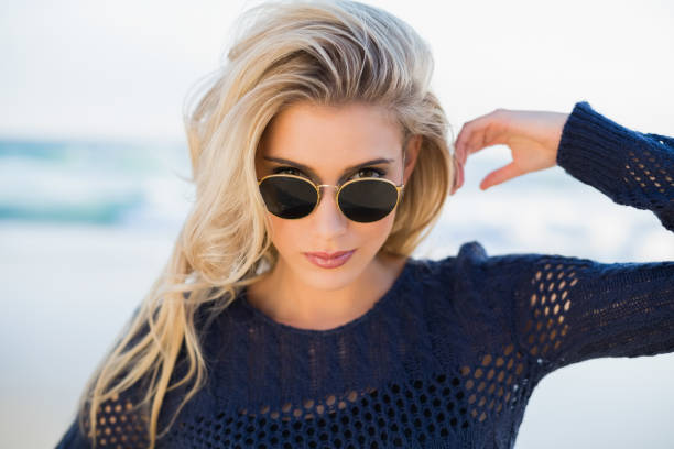 istock Gorgeous sensual blonde looking over her sunglasses 836684914