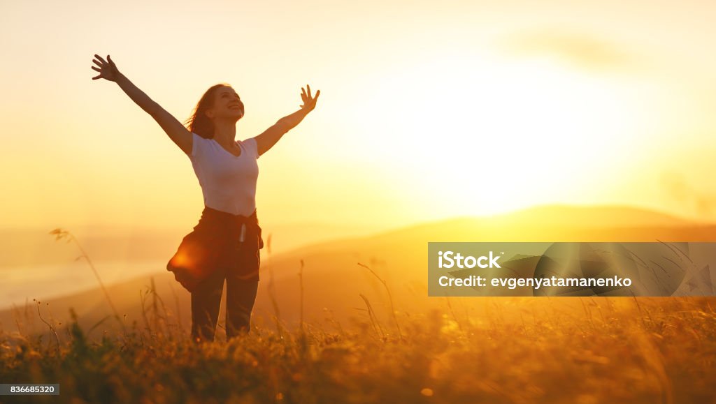 Happy woman   on sunset in nature iwith open hands Happy woman   on the sunset in nature in summer with open hands Women Stock Photo