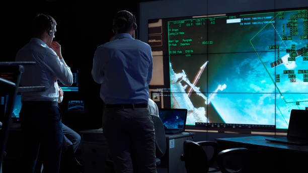 People working in mission control center A group of people are controlling the orbiting international space station ISS. Elements of this image furnished by NASA. flight instruments stock pictures, royalty-free photos & images