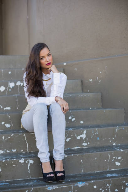 istock Attractive woman with red lips sitting on stairs 836703982