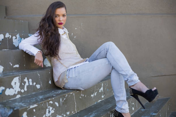 istock Attractive woman with red lips sitting on stairs posing 836704240