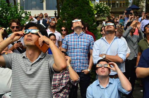 New York, NY, USA August 21, 2017 New Yorker gather in Manhattan's Byrant park to view the solar eclipse.