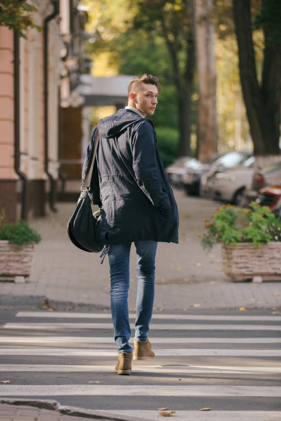 istock Hipster guy walking down the street, urban style 836723498