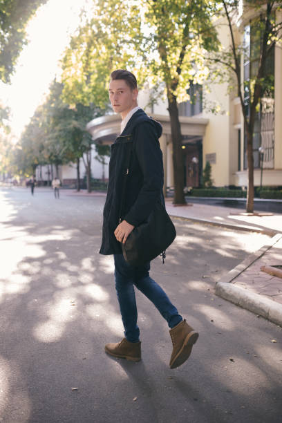istock Hipster guy walking down the street, urban style 836724370