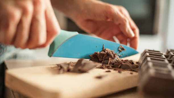 istock Woman hands chopping chocolate block for celebratory cake 836753962