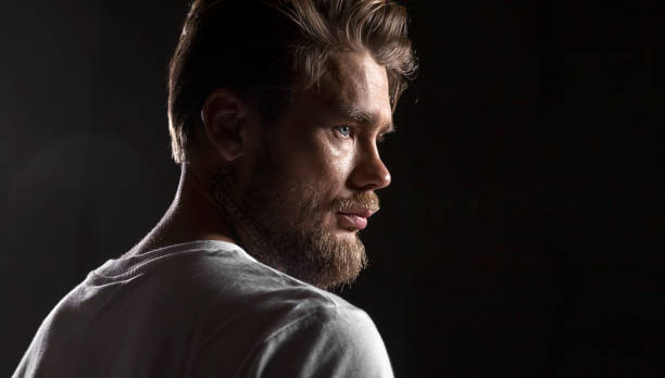 istock Close up face bearded man in white t-shirt on black background 836754124