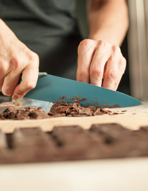istock Woman hands chopping chocolate block for celebratory cake 836754970