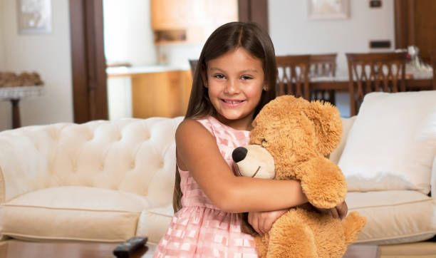 istock Smiling little girl holding a teddy bear 836768618