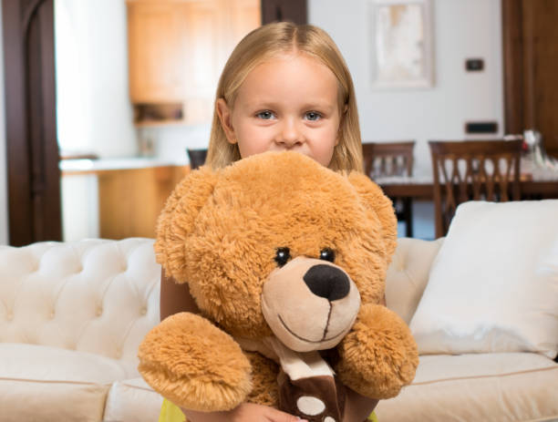 istock Little girl holding a teddy bear 836768918