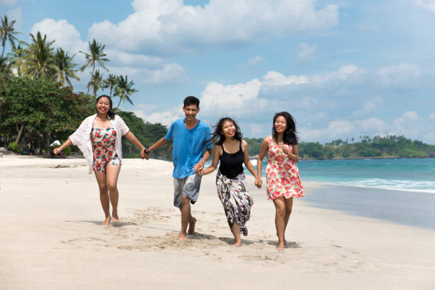 istock Friends running and having fun on the beach 836782212