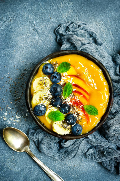 istock Mango smoothie bowl with fresh ripe berries and fruits 836786588