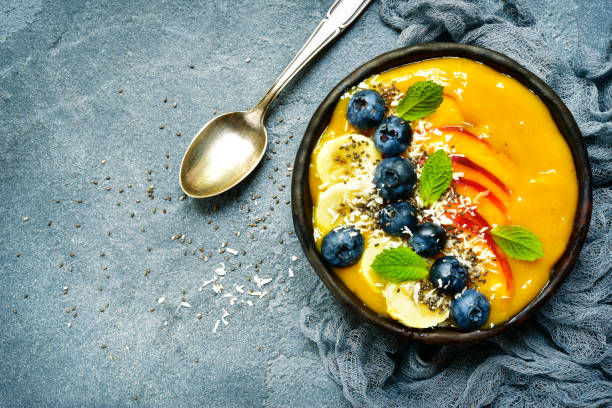 istock Mango smoothie bowl with fresh ripe berries and fruits 836786598