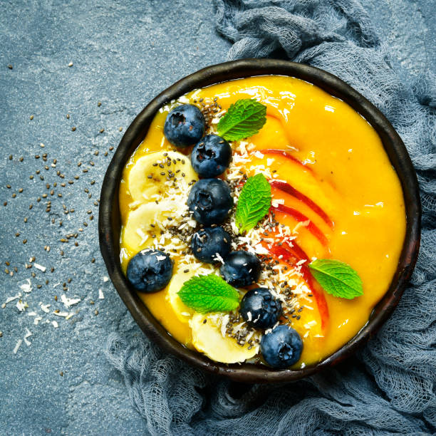 istock Mango smoothie bowl with fresh ripe berries and fruits 836786774