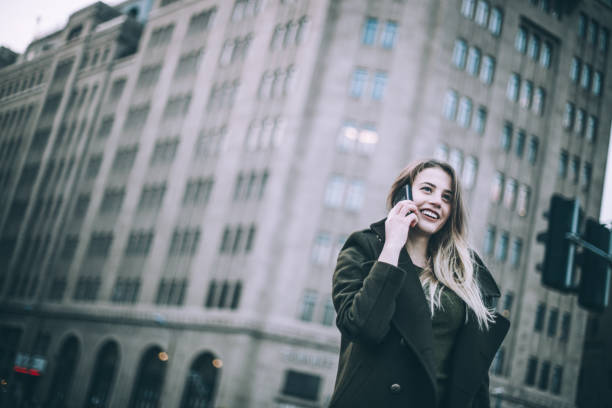 istock Beautiful young woman using mobile on the street 836786776