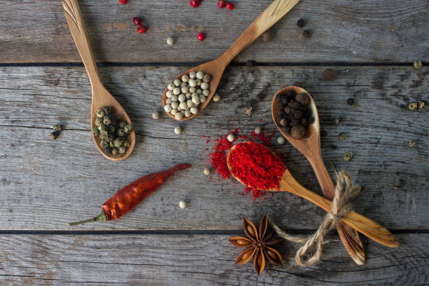 istock pepper mix in wooden spoons on rustic table, colorful indian spices 836794260