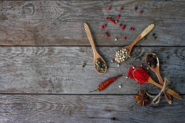 istock pepper mix in wooden spoons on rustic table, colorful indian spices 836794874