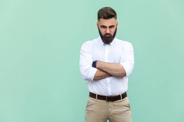 istock Resentful man, with arms folded, over light green background 836798060