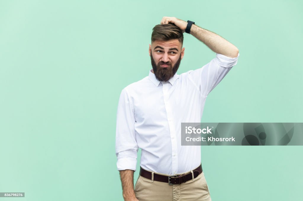 Not sure. Young adult businessman have a doubt. Confusion Stock Photo