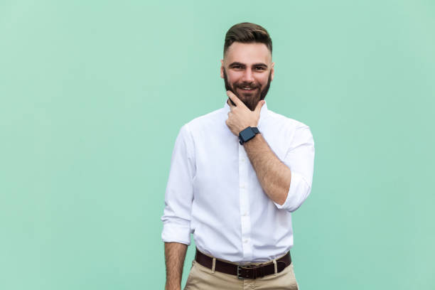 istock Stylish bearded man with appealing dark eyes smiling into camera. Hipster guy with beard grinning having cheerful look. Positive emotions. Indoor, studio shot 836798438