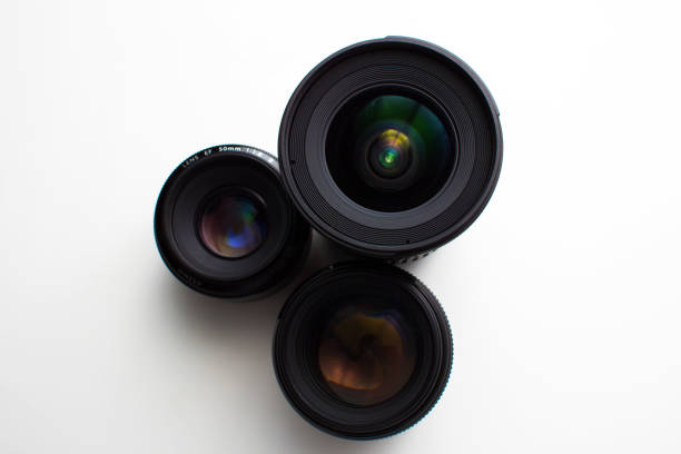 istock close-up view of a group of camera lenses on a white surface 836809460