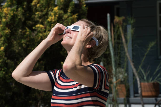 Woman Watching Eclipse stock photo