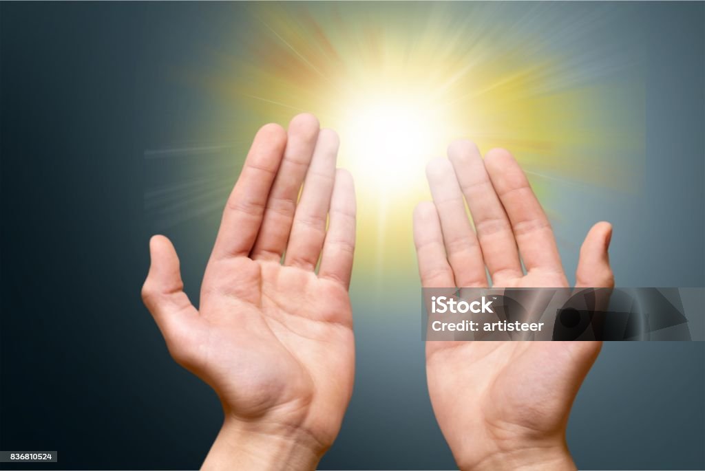 Universal. Human hands holding flashlight  on background Distant Stock Photo